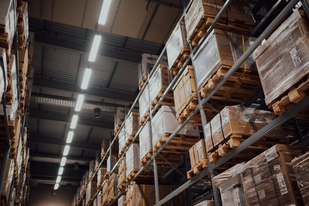 Logistic and shippment hall with several pallets on shelf system full of delivered materiel